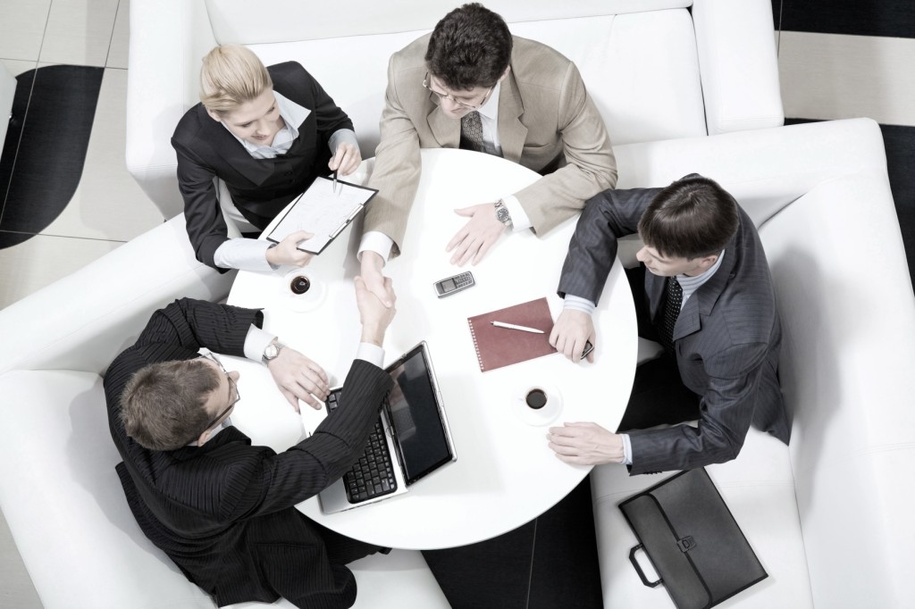 Portrait of business men shaking hands at meeting